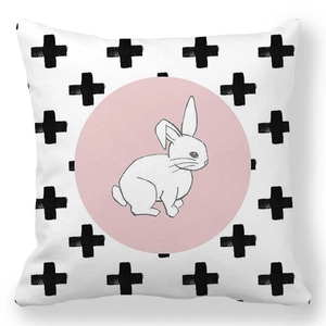 Close-up of Easter peach skin pillowcase with pink rabbit and black cross pattern
