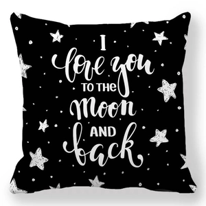 Detail of a square black pillowcase with white stars and 'I love you to the moon' text