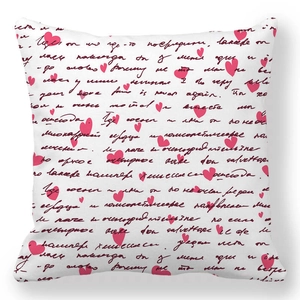 Detail of red heart patterns and artistic black script on a white peach skin pillowcase