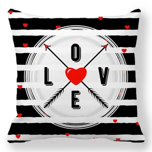 Detail of soft peach skin pillowcase with black stripes, red hearts and LOVE letters