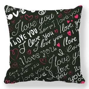 Detail of black peach skin pillowcase with white I love you script and pink hearts