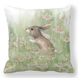 Detail of watercolor rabbit and daisies print on soft peach skin fabric throw pillow cover
