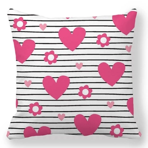 Detail of square pillowcase featuring pink heart and floral prints on black striped background