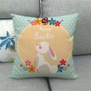 Detail of Happy Easter linen pillowcase with rabbit and flowers on a sofa
