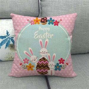 Detail showing the Happy Easter bunny linen pillowcase texture on a cozy fabric sofa