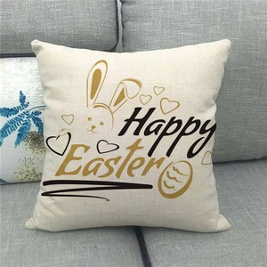 Close-up of Happy Easter linen pillowcase with rabbit and heart patterns on grey sofa