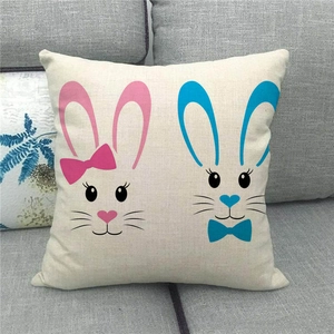 Detalle de funda de cojín de Pascua en lino con conejos minimalistas sobre un sofá gris