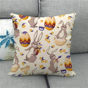 Close-up of Easter linen pillow cover with bunny and egg pattern on a grey sofa