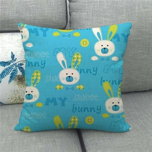 Sky blue linen pillowcase with bunny pattern and MY sweet bunny text on a grey sofa
