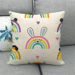 Linen Easter pillow cover detail with cute cartoon rabbit and rainbow on grey sofa