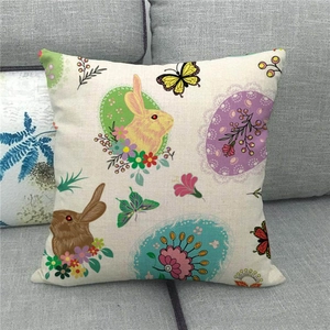 Easter decorative linen pillowcase featuring colorful bunnies and flowers on a sofa