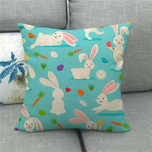 Detail of teal Easter rabbit linen cushion cover showing woven texture on a grey sofa