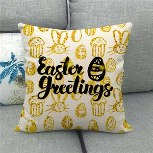 Close-up of linen Easter pillow cover with golden rabbit patterns and Easter Greetings text