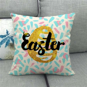 Easter decorative linen pillowcase with golden glitter egg print on a grey sofa