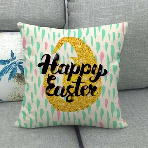 Linen Happy Easter pillow cover with golden egg design on a modern grey sofa