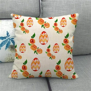 Easter pillowcase with orange roses and colorful eggs on linen fabric over a grey sofa