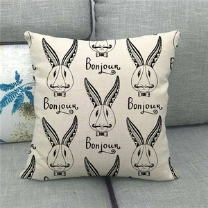 Detail showing natural linen texture and black rabbit print on a square pillow cover