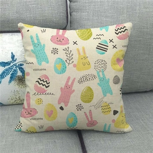 Close-up of Easter linen pillowcase with colorful rabbits and eggs on a sofa