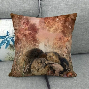 Detail of linen pillowcase featuring two sleeping rabbits in a cozy autumn forest setting