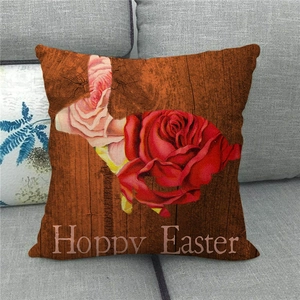 Detailed texture of linen Happy Easter pillowcase with red roses on gray sofa