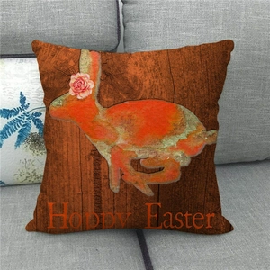 Macro shot of linen Easter pillow cover with rabbit silhouette and Hoppy Easter text