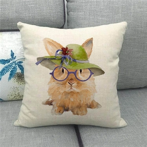 Detail view of linen pillowcase featuring a watercolor bunny in glasses on a grey sofa