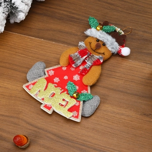 Detail of gingerbread man Christmas ornament with Noel sign on rustic wood surface