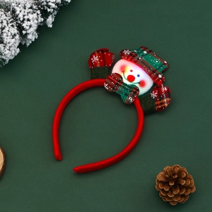 Luminous snowman Christmas headband with red plaid hat and gloves on festive pine backdrop