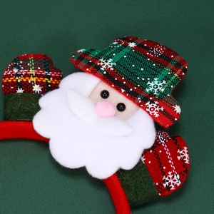 Detailed close-up of a Christmas headband with Santa figure in red and green plaid fabric