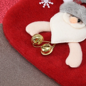 Detail of red felt Christmas gift bag featuring 3D Santa Claus and golden bells