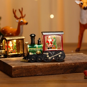 Detail shot of a light-up Christmas train with Santa Claus and warm LED light