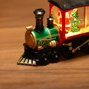 Detail of vintage green Christmas train lamp with warm LED light and Santa miniature