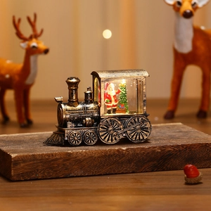 Close-up of vintage lighted Christmas train ornament featuring Santa and warm LED glow