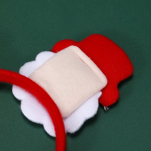 Close-up detail of soft red and white felt texture on festive Christmas headband