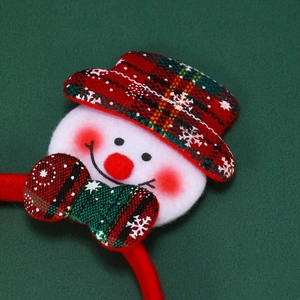 Detail of plush snowman Christmas headband featuring festive red plaid mini hat and bow
