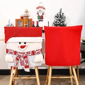 Detail of knitted snowman chair covers with red 3D hats and festive holiday decorations