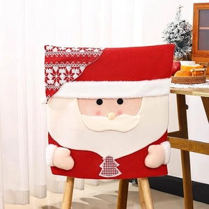 Detail of knitted Santa Claus chair cover with plush trim and festive tree patterns