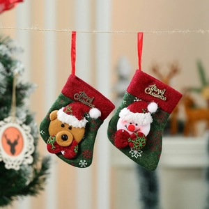Set of two green Christmas stockings with 3D bear and snowman hanging on a tree