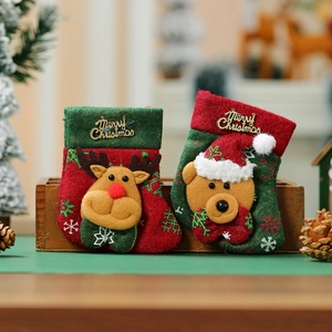 Close-up of mini Christmas stockings with 3D reindeer and bear patches in a wooden box