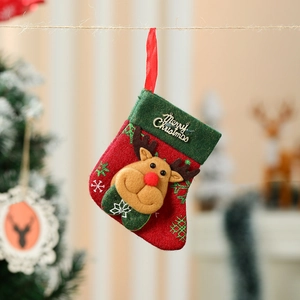 Close-up of red Christmas stocking with 3D reindeer doll and golden Merry Christmas text