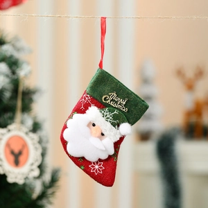 Detail of red felt Christmas stocking ornament with Santa Claus and Merry Christmas sign