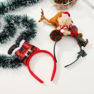 Vue détaillée de serre-têtes de Noël avec ours en peluche, jambes de Père Noël et nœuds