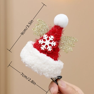 Detail view of mini Christmas hat hair clip with gold wings and size measurement text