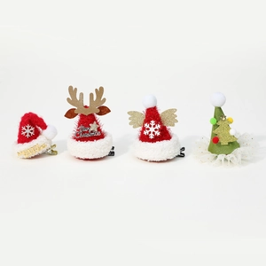 Set of four Christmas hair clips featuring reindeer antlers and plush holiday designs
