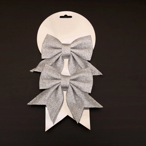 Detail of silver sequined Christmas bows with long tails on display card