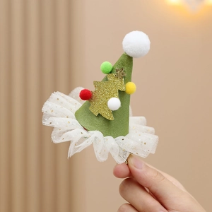 Close-up of Christmas tree hair clip with plush balls, gold glitter and lace trim