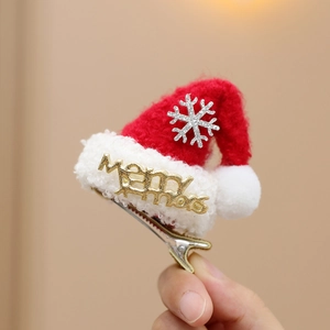 Macro view of a mini Christmas hat hair clip with Merry letters and rhinestone snowflake
