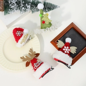 Detailed view of four Christmas hair clips featuring reindeer antlers and sequin hats