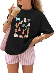 Detail of a black cotton T-shirt featuring vibrant cartoon dog prints for kids