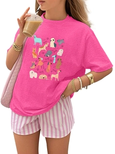 Detail of pink cotton T-shirt featuring colorful cartoon dog prints and round neck